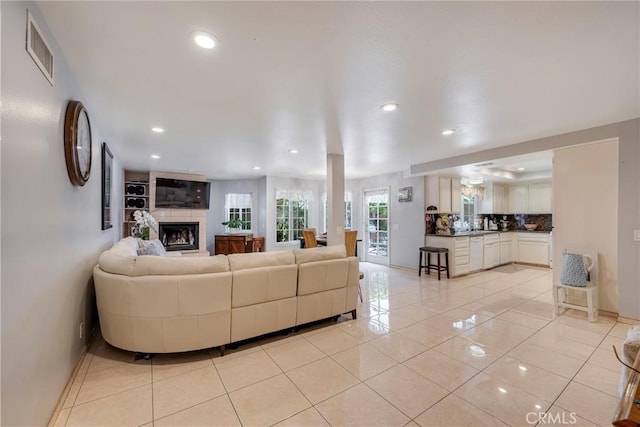 9909 Merced River Ave, Fountain Valley, CA 92708 - living room featuring recessed lighting, light tile patterned floors, and a tiled fireplace