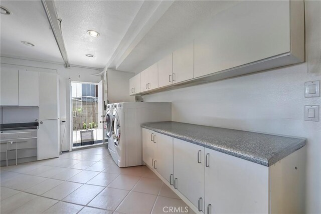 9909 Merced River Ave, Fountain Valley, CA 92708 - washroom featuring cabinet space, washer and dryer, a textured ceiling, and light tile patterned flooring