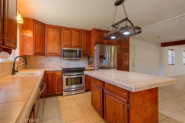 246 E Shasta St, Orland, CA 95963 - kitchen with stainless steel appliances, decorative backsplash, tile counters, and brown cabinetry