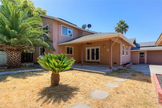 246 E Shasta St, Orland, CA 95963 - rear view of house featuring ceiling fan, a patio area, french doors, board and batten siding, and solar panels
