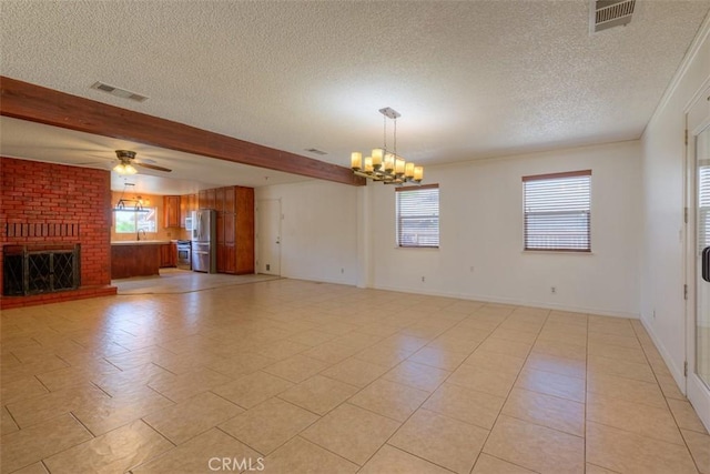 246 E Shasta St, Orland, CA 95963 - unfurnished living room featuring a textured ceiling, a chandelier, healthy amount of natural light, ceiling fan, and beamed ceiling