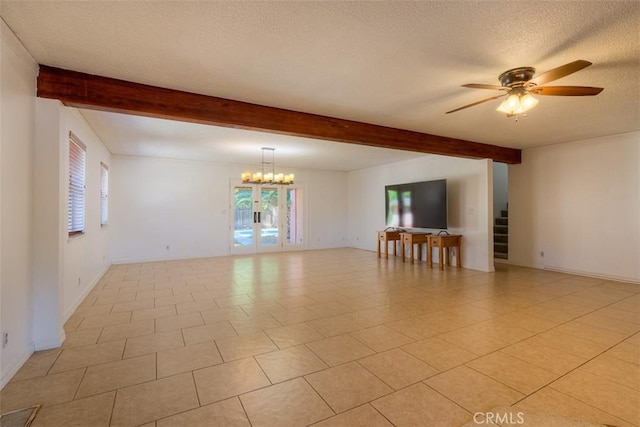 246 E Shasta St, Orland, CA 95963 - empty room featuring beamed ceiling, plenty of natural light, ceiling fan, a textured ceiling, and stairs