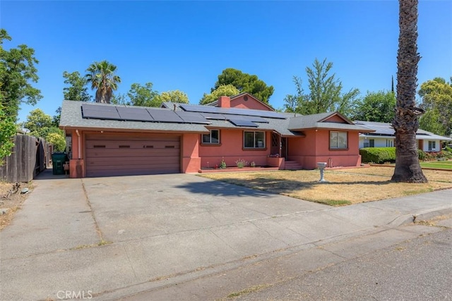 246 E Shasta St, Orland, CA 95963 - single story home with an attached garage, driveway, roof mounted solar panels, and stucco siding
