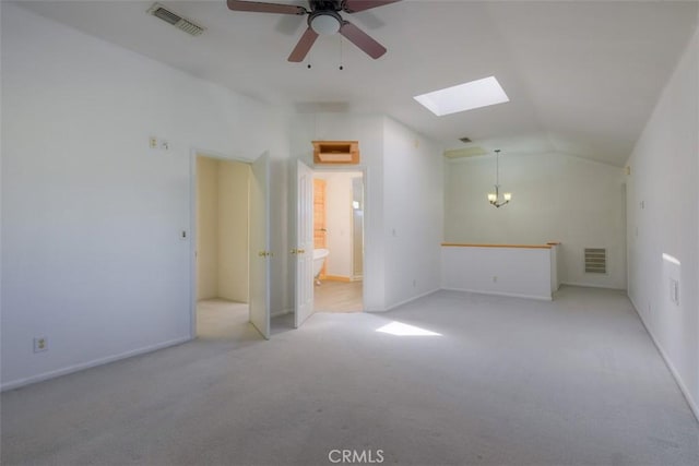 246 E Shasta St, Orland, CA 95963 - unfurnished room featuring vaulted ceiling, a skylight, light colored carpet, ceiling fan, and a chandelier