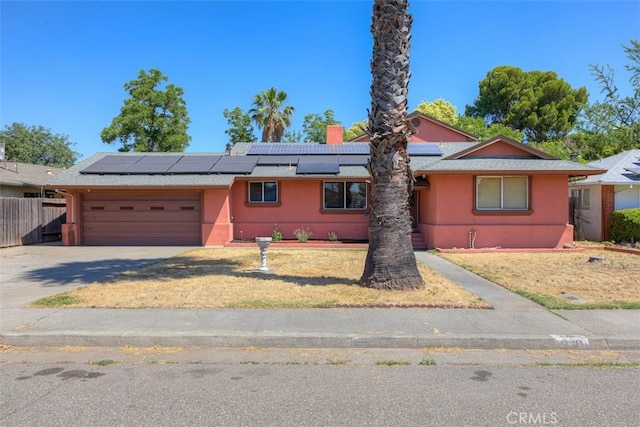 246 E Shasta St, Orland, CA 95963 - single story home with an attached garage, driveway, solar panels, and stucco siding
