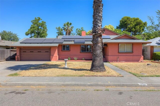 246 E Shasta St, Orland, CA 95963 - single story home with an attached garage, driveway, solar panels, and stucco siding