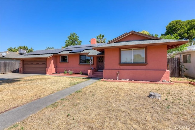 246 E Shasta St, Orland, CA 95963 - ranch-style house featuring solar panels, stucco siding, an attached garage, and concrete driveway