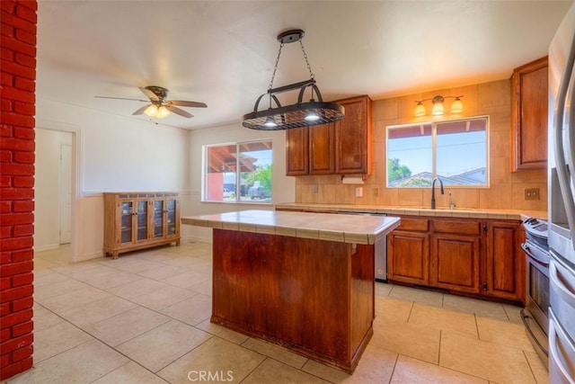 246 E Shasta St, Orland, CA 95963 - kitchen with tile countertops, plenty of natural light, and light tile patterned floors
