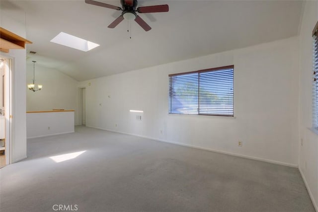 246 E Shasta St, Orland, CA 95963 - carpeted spare room featuring vaulted ceiling, a skylight, a ceiling fan, and a chandelier