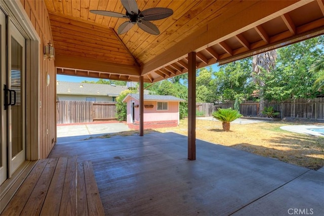 246 E Shasta St, Orland, CA 95963 - fenced backyard featuring an outdoor structure, ceiling fan, a patio area, and a wooden deck