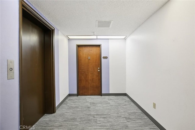 18900 Delaware St Unit 214, Huntington Beach, CA 92648 - hallway with elevator and a textured ceiling