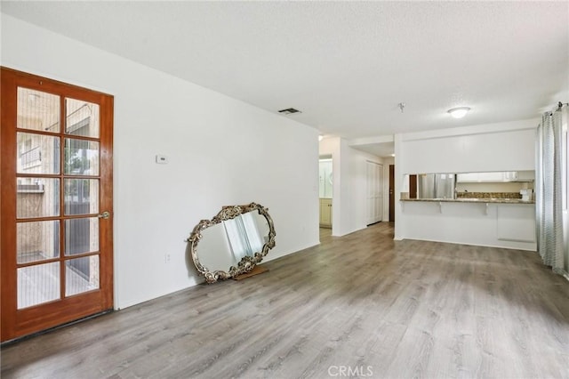 18900 Delaware St Unit 214, Huntington Beach, CA 92648 - unfurnished living room featuring wood finished floors