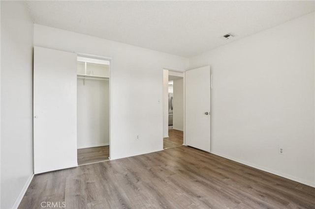 18900 Delaware St Unit 214, Huntington Beach, CA 92648 - unfurnished bedroom with wood finished floors and a closet