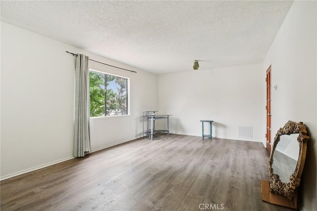 18900 Delaware St Unit 214, Huntington Beach, CA 92648 - spare room with wood finished floors and a textured ceiling
