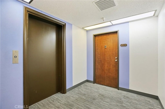 18900 Delaware St Unit 214, Huntington Beach, CA 92648 - hallway featuring carpet, a textured ceiling, and elevator