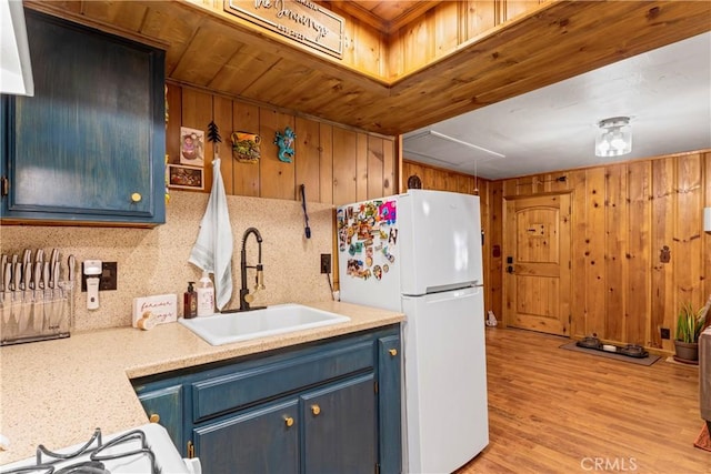 32135 W Dr, Running Springs, CA 92382 - kitchen featuring freestanding refrigerator, wooden ceiling, blue cabinetry, wooden walls, and light countertops