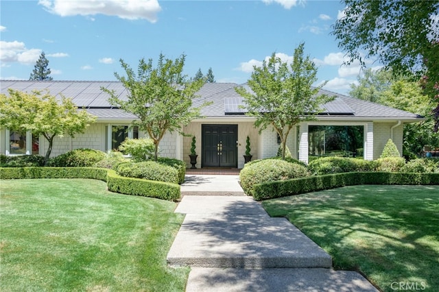 2640 Tenaya Way, Fresno, CA 93711 - ranch-style home with a front yard, solar panels, and french doors