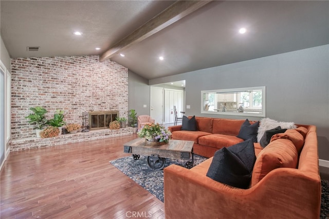2640 Tenaya Way, Fresno, CA 93711 - living room featuring wood finished floors, brick wall, and a fireplace