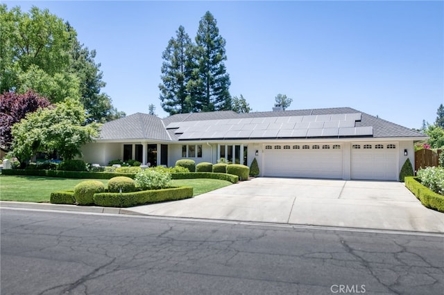 2640 Tenaya Way, Fresno, CA 93711 - single story home with an attached garage, driveway, roof mounted solar panels, and a front yard