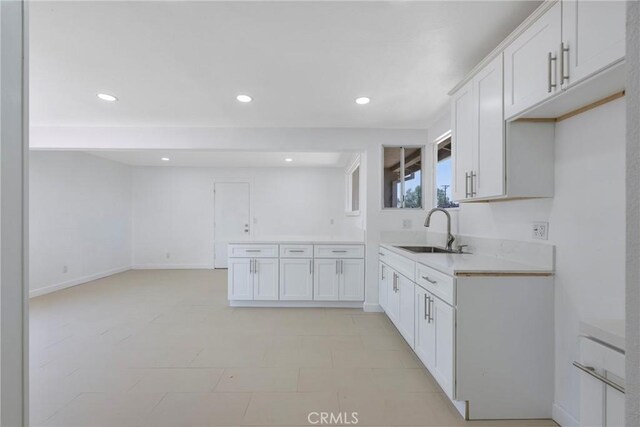 8888 Patrero St, Riverside, CA 92503 - kitchen with light countertops, recessed lighting, white cabinetry, open floor plan, and a peninsula