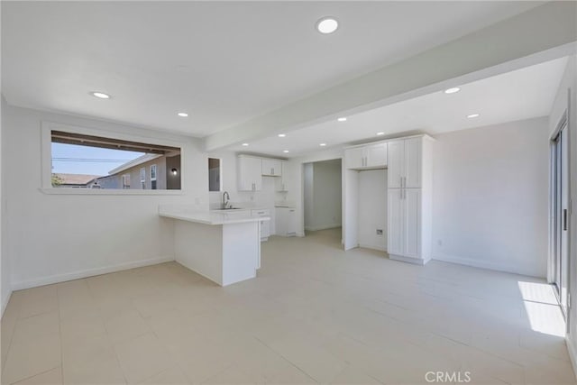 8888 Patrero St, Riverside, CA 92503 - kitchen with a peninsula, white cabinetry, recessed lighting, and light countertops