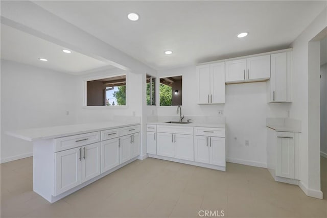 8888 Patrero St, Riverside, CA 92503 - kitchen with light countertops, recessed lighting, a peninsula, and white cabinets
