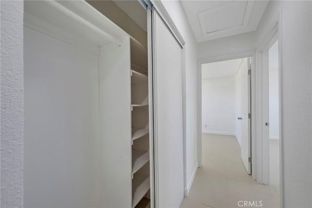8888 Patrero St, Riverside, CA 92503 - hallway featuring attic access and light tile patterned floors