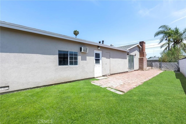 8888 Patrero St, Riverside, CA 92503 - back of property with a fenced backyard, a patio, stucco siding, and an AC wall unit