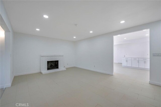 8888 Patrero St, Riverside, CA 92503 - unfurnished living room with a brick fireplace and recessed lighting