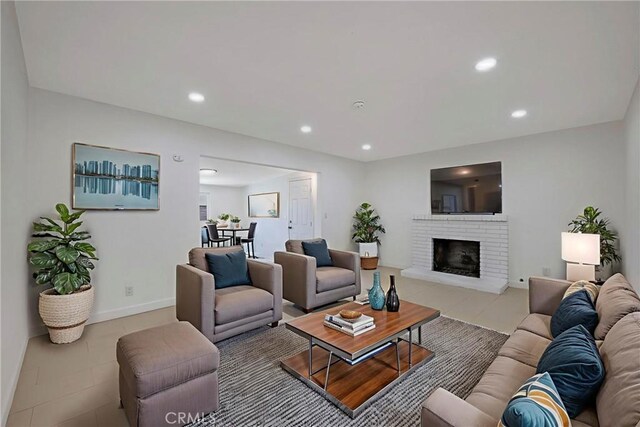 8888 Patrero St, Riverside, CA 92503 - living room with recessed lighting, light tile patterned floors, and a brick fireplace
