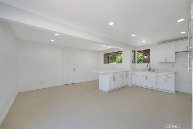 8888 Patrero St, Riverside, CA 92503 - kitchen featuring white cabinetry, recessed lighting, a peninsula, light countertops, and open floor plan
