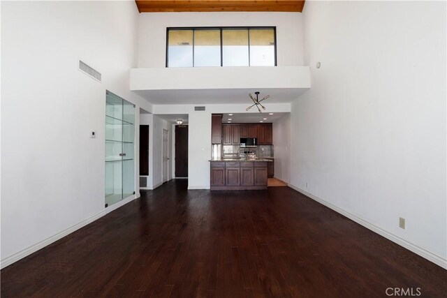 435 S La Fayette Park Pl Unit 311, Los Angeles, CA 90057 - unfurnished living room with a high ceiling and dark wood-type flooring