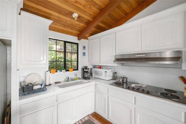 1799 Saint Thomas Ave, Cambria, CA 93428 - kitchen with white microwave, range hood, wooden ceiling, white cabinets, and light countertops