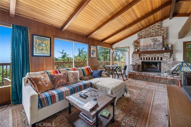 1799 Saint Thomas Ave, Cambria, CA 93428 - living room with a wooden ceiling with exposed beams, plenty of natural light, a fireplace, high vaulted ceiling, and wooden walls
