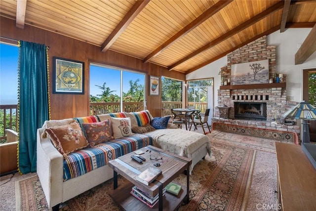 1799 Saint Thomas Ave, Cambria, CA 93428 - living room featuring a wood ceiling with exposed beams, plenty of natural light, a brick fireplace, high vaulted ceiling, and wooden walls