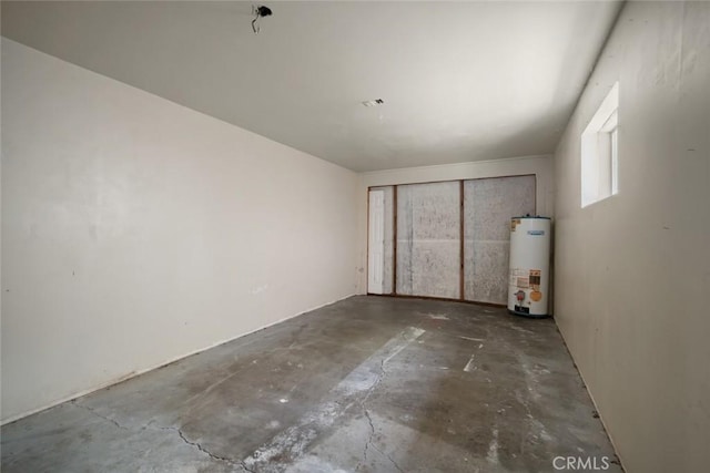 1799 Saint Thomas Ave, Cambria, CA 93428 - empty room with gas water heater and concrete floors