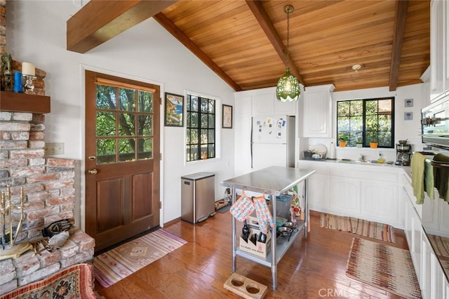1799 Saint Thomas Ave, Cambria, CA 93428 - kitchen with light wood-type flooring, wood ceiling, white cabinets, freestanding refrigerator, and refrigerator