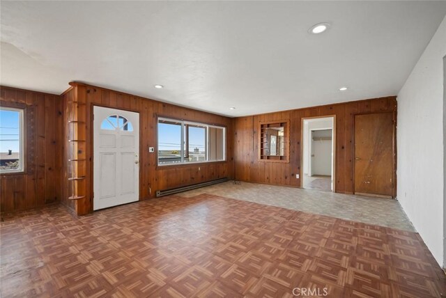 1799 Saint Thomas Ave, Cambria, CA 93428 - entryway with baseboard heating, wood walls, healthy amount of natural light, recessed lighting, and parquet flooring