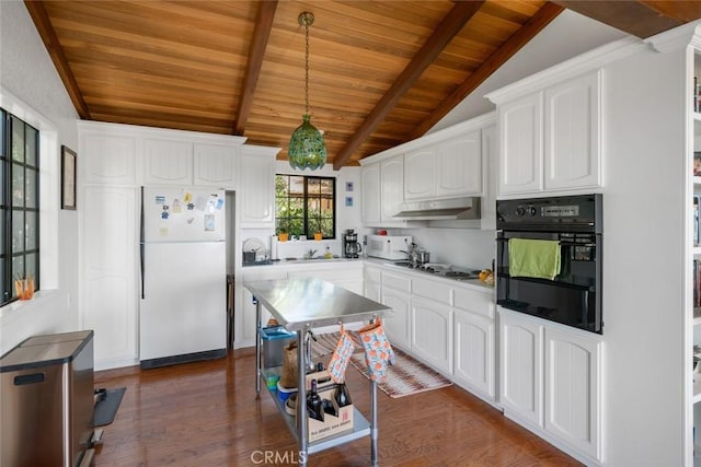 1799 Saint Thomas Ave, Cambria, CA 93428 - kitchen featuring freestanding refrigerator, black oven, wooden ceiling, dark wood-style flooring, and white cabinetry