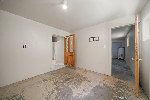 1799 Saint Thomas Ave, Cambria, CA 93428 - spare room featuring strapped water heater and unfinished concrete floors