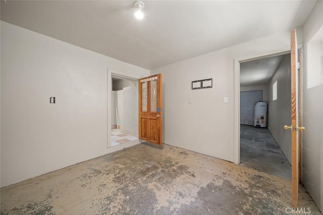 1799 Saint Thomas Ave, Cambria, CA 93428 - spare room with secured water heater and unfinished concrete floors