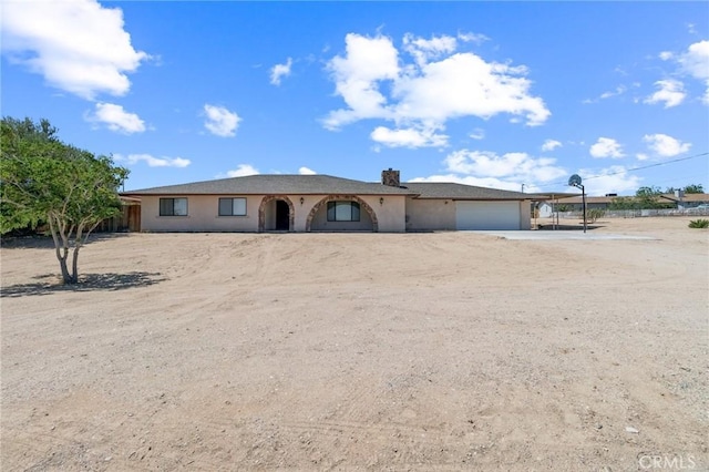 27363 Azurite Rd, Barstow, CA 92311 - ranch-style home featuring an attached garage, dirt driveway, and stucco siding