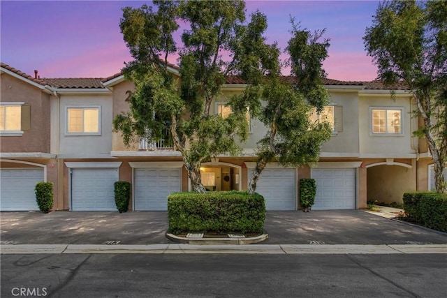 93 Kansas St Unit 205, Redlands, CA 92373 - multi unit property with an attached garage, stucco siding, a tiled roof, and driveway