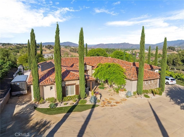 33260 Susan Grace Ct, Temecula, CA 92592 - view of front of house featuring a tile roof, a mountain view, stucco siding, and stone siding