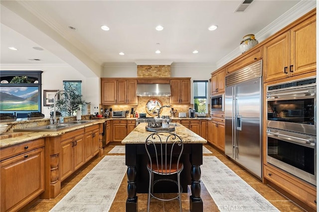 33260 Susan Grace Ct, Temecula, CA 92592 - kitchen with built in appliances, wall chimney exhaust hood, light stone countertops, ornamental molding, and a center island