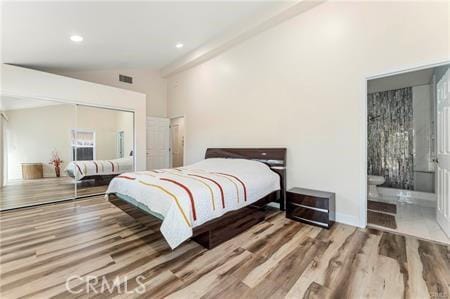7922 Ducor Ave, West Hills, CA 91304 - bedroom featuring wood finished floors, a closet, vaulted ceiling, recessed lighting, and ensuite bathroom