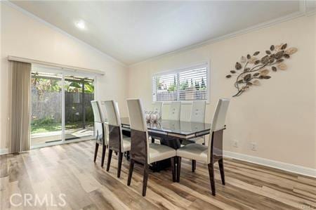 7922 Ducor Ave, West Hills, CA 91304 - dining room featuring crown molding, wood finished floors, and vaulted ceiling