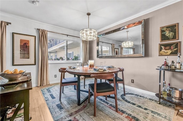1203 N Sweetzer Ave Unit 215, West Hollywood, CA 90069 - dining room featuring a chandelier, ornamental molding, and wood finished floors