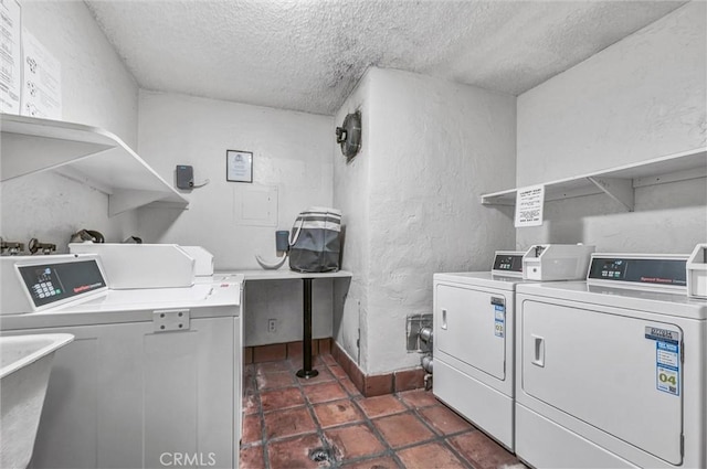 1203 N Sweetzer Ave Unit 215, West Hollywood, CA 90069 - communal laundry room with independent washer and dryer, a textured ceiling, dark tile patterned floors, and a textured wall