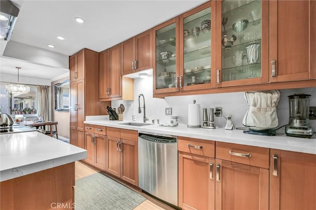 1203 N Sweetzer Ave Unit 215, West Hollywood, CA 90069 - kitchen with dishwasher, brown cabinets, light countertops, hanging light fixtures, and recessed lighting